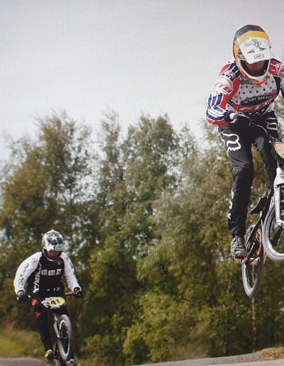 BMX jumping into lead